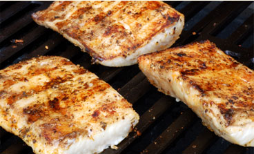 Fish filets being cooked on a grill