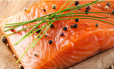 Seasonded salmon steak on a cutting board